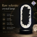 Raw selenite crystal lamp with glowing interior on a dark background, featuring AstroPreet branding.