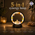 5-in-1 synergy lamp with crystals on a wooden surface, surrounded by plants and candles.